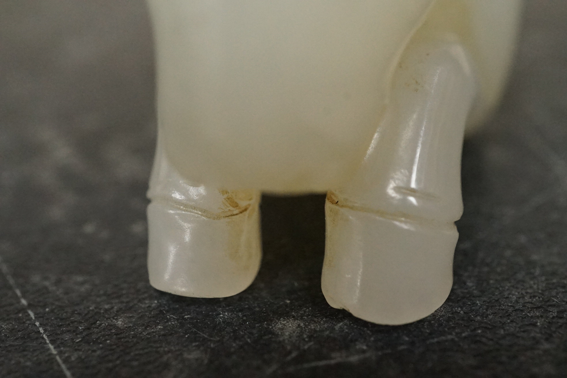 A Chinese white jade figure of a recumbent horse